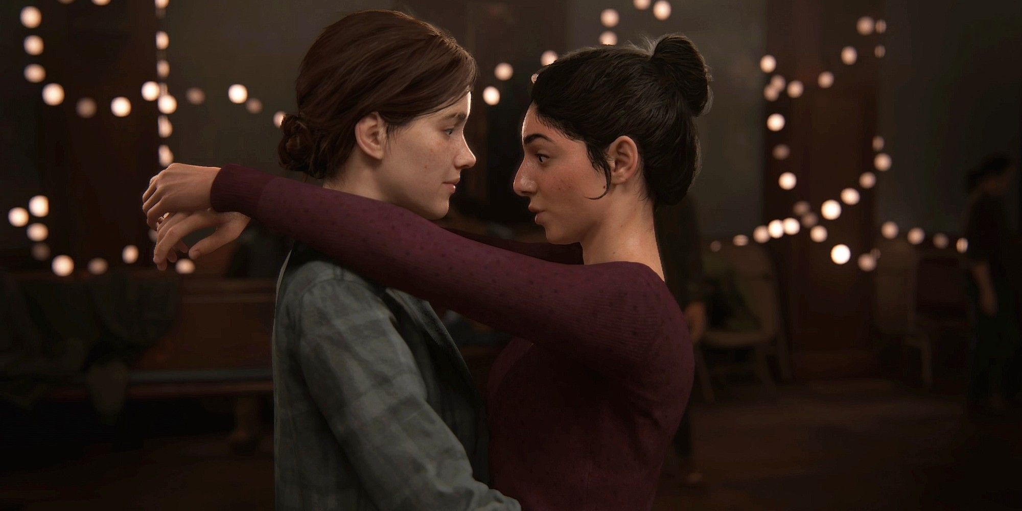 The Last Of Us Part 2 screenshot of Ellie and Dina looking into each other's eyes.