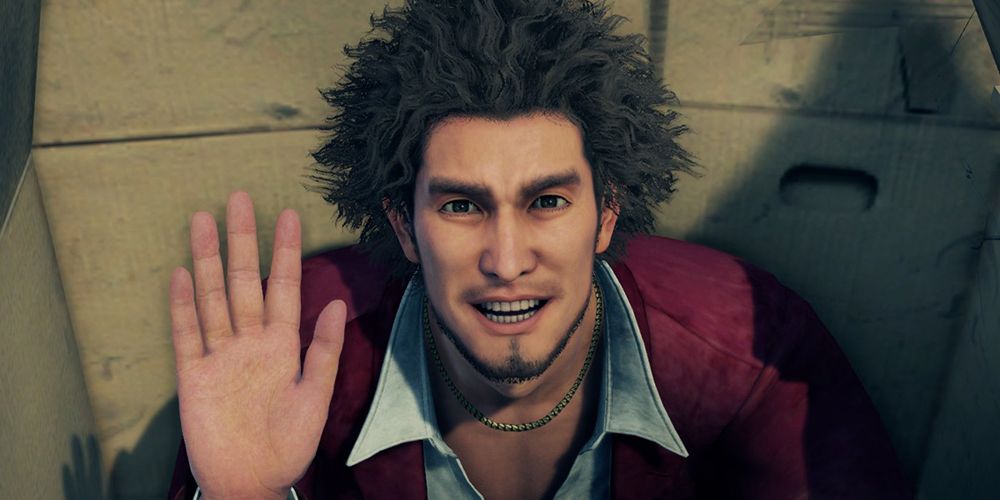 Screenshot of Ichiban Kasuga waving to the camera in Yakuza Like a Dragon.