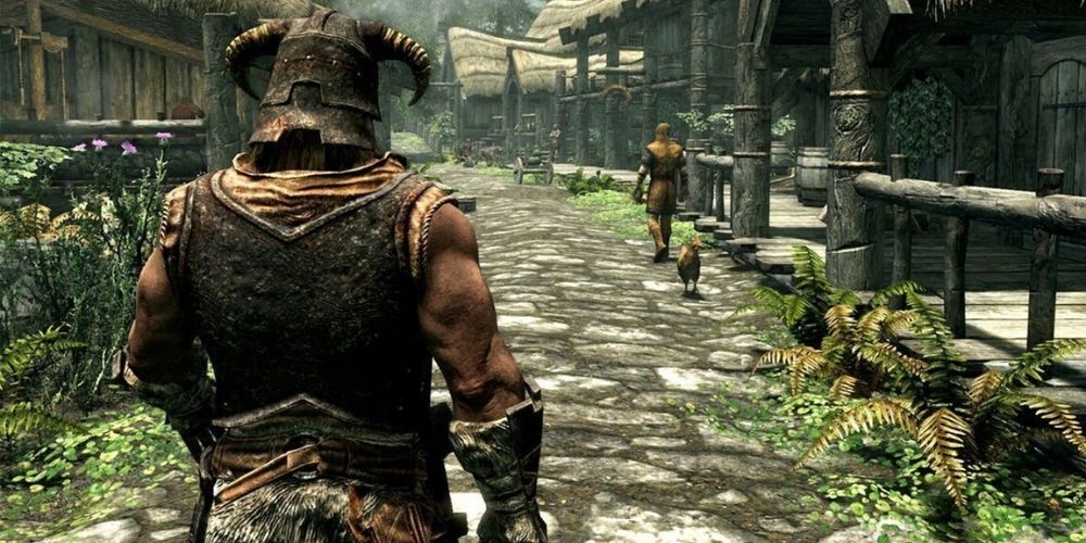 Skyrim screenshot of protagonist walking down cobble road.