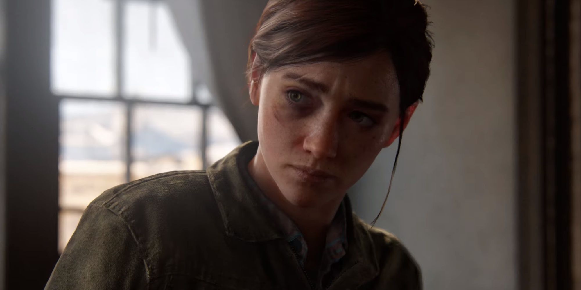 Ellie in the last of us part 2 remastered looking sorrowful to the side in her room at the farmhouse.