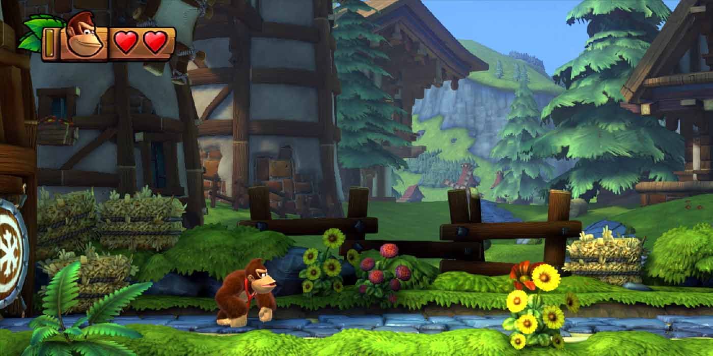 Donkey Kong standing on a grassy path in a cozy village from Donkey Kong Country: Tropical Freeze.