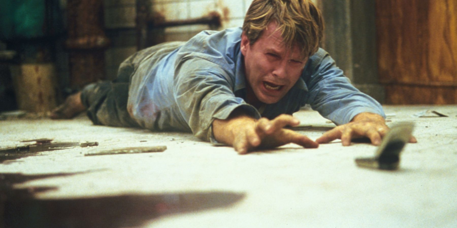 Adam lying on the floor in Saw (2004)