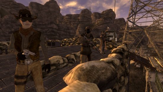 Three people standing guard near the entrance of a base in The Inheritance, one of the best Fallout New Vegas mods.