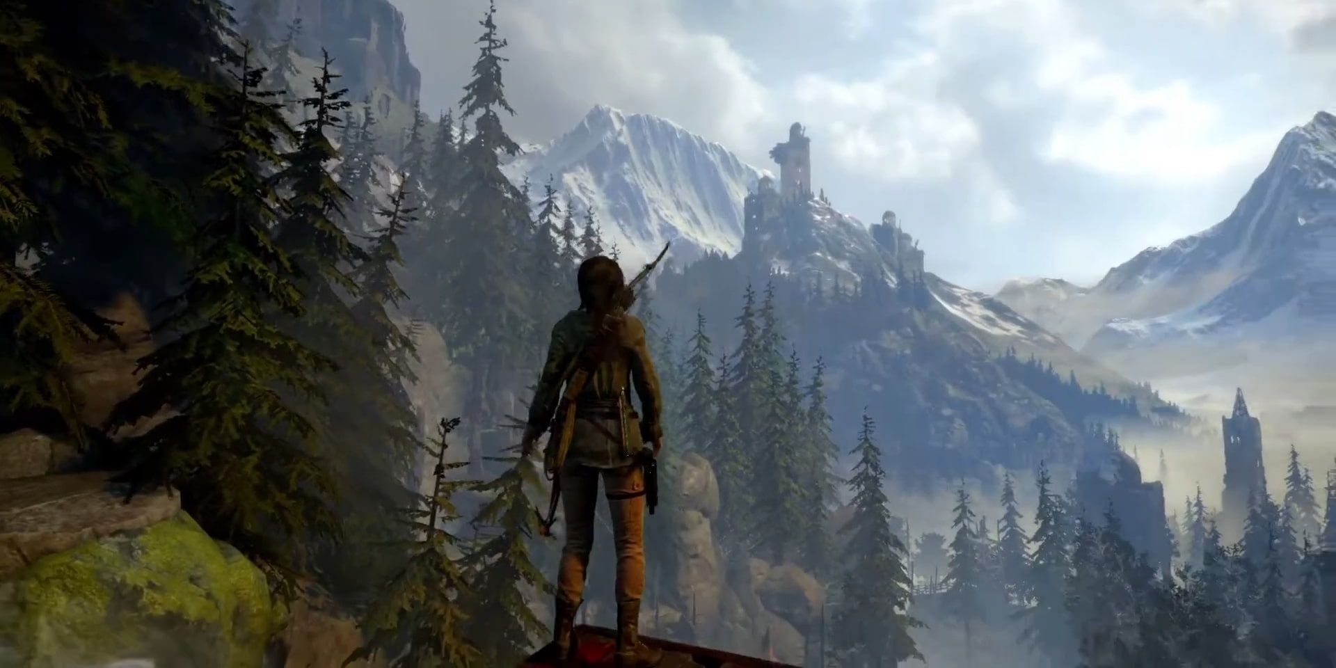 Screenshot of Lara Croft taking in the view of the mountains in Rise of the Tomb Raider.