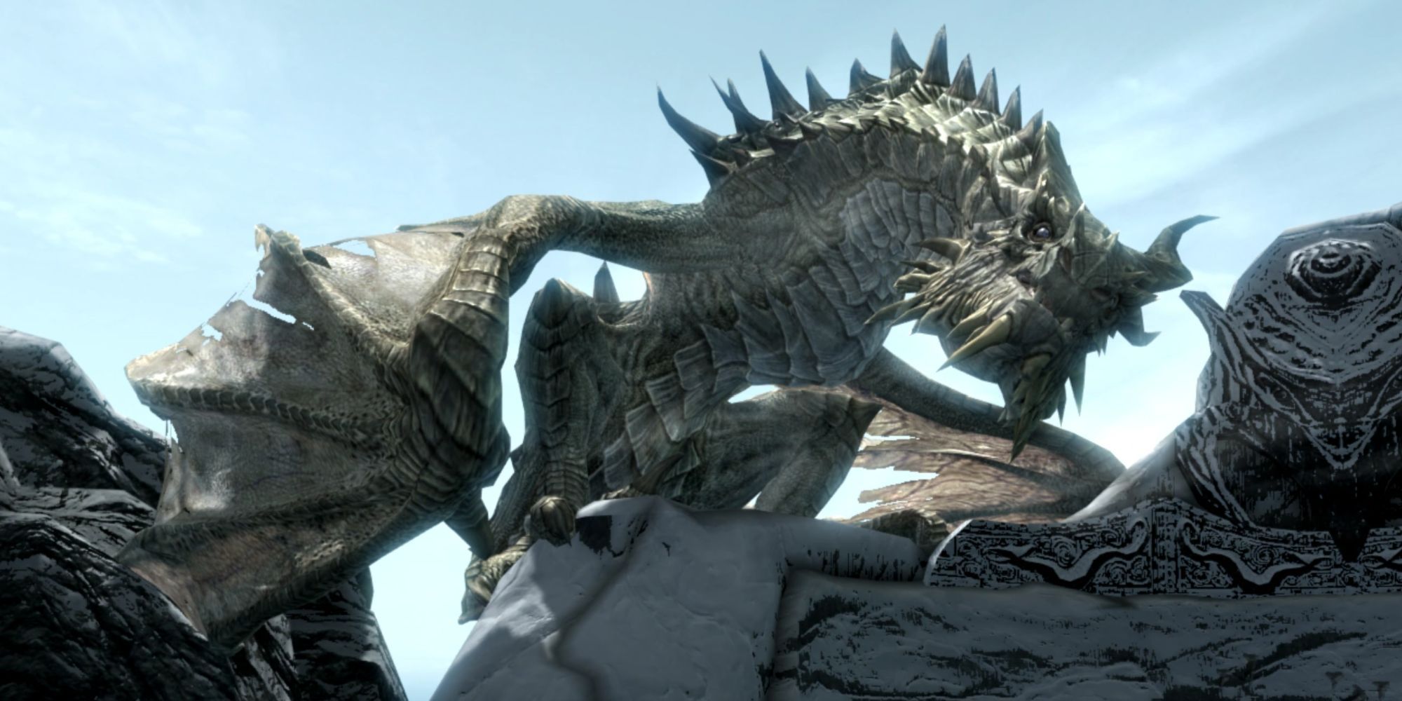 Skyrim screenshot of Paarthurnax sitting on a wall.