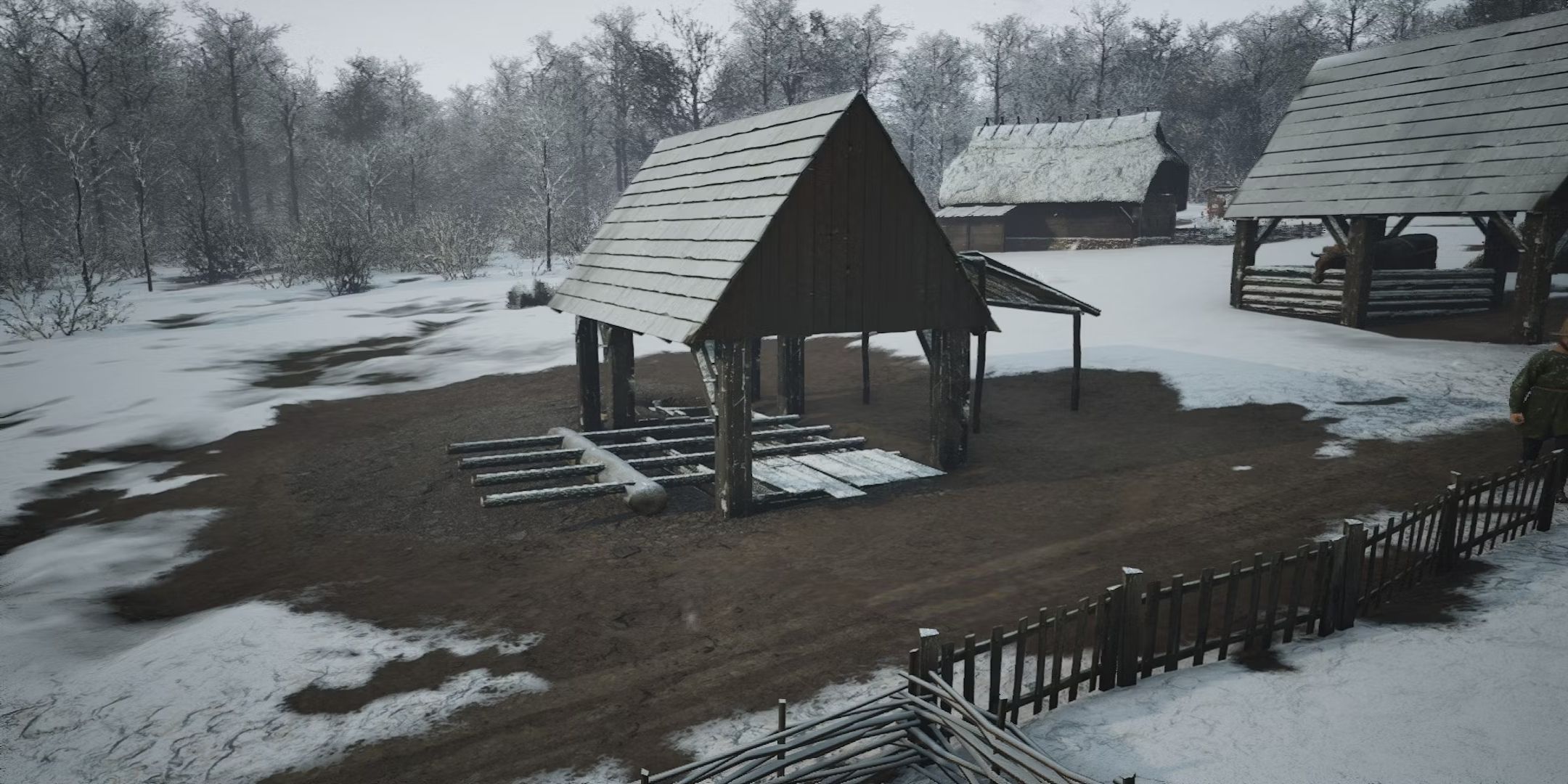 Manor Lords screenshot of sawpit covered in snow.