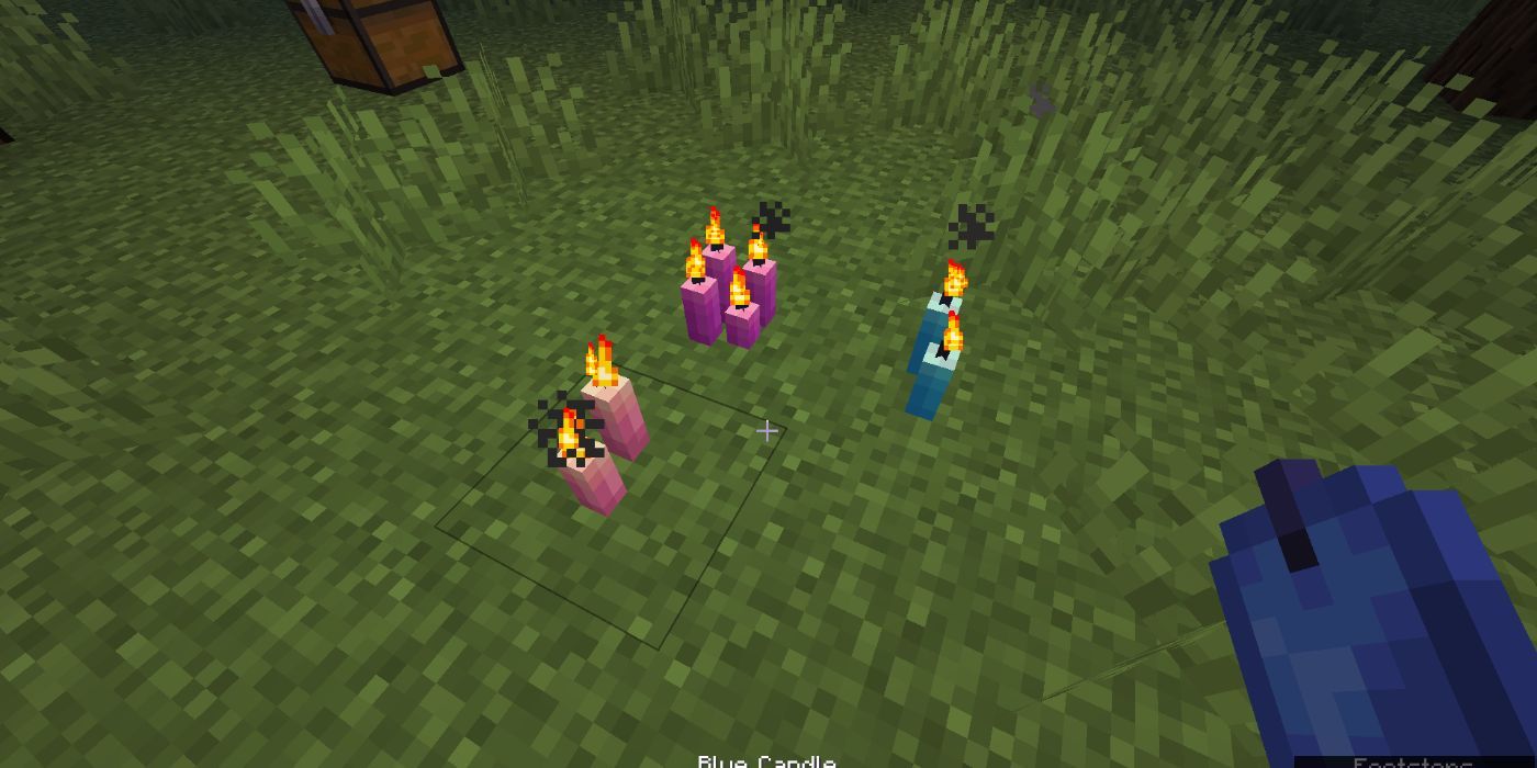 A player looking at lit candles on the ground. 