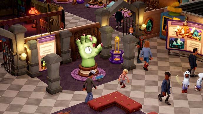 Two Point Museum screenshot showing giant green hand with cyclops eye as an exhibit