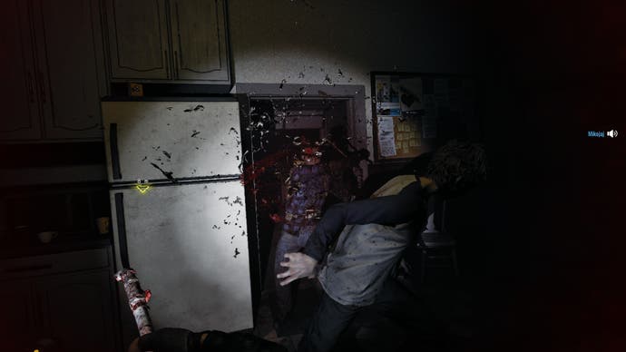 A screenshot of No More Room In Hell 2, showing the player and another player cooperatively bludgeoning a zombie in a kitchen doorway.