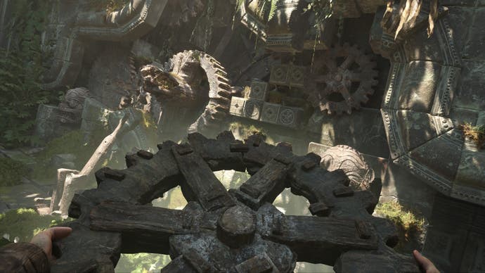 The player holds a large wooden cog in front of an elaborate contraptiob in Indiana Jones and the Great Circle.