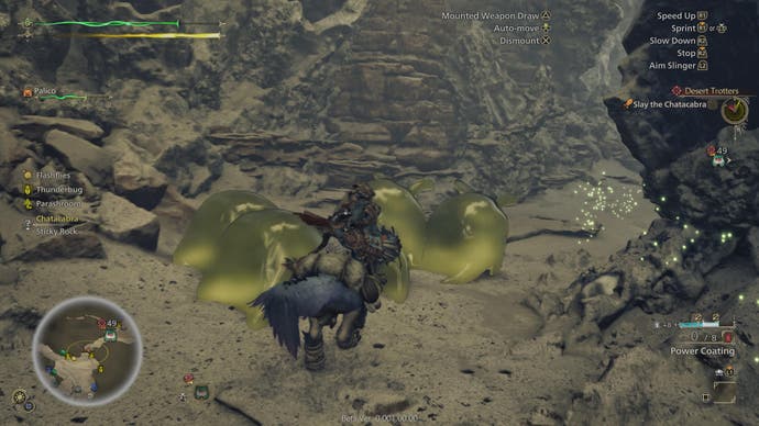 Monster Hunter Wilds beta screenshot showing player character riding past golden blobs in rocky region