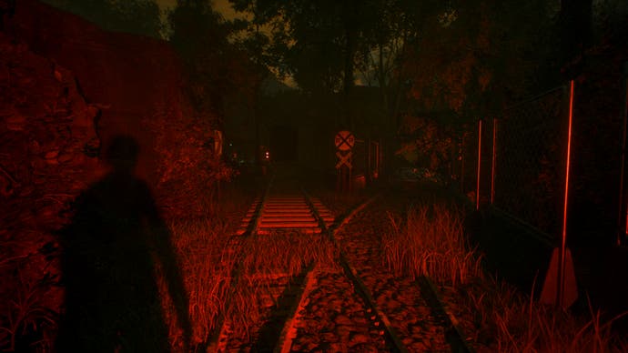 A Quiet Place: The Road Ahead official screenshot showing a dark room with red lighting