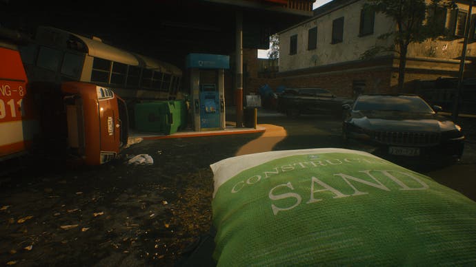 A Quiet Place: The Road Ahead official screenshot showinga sandbag in the foreground amongst cars and houses