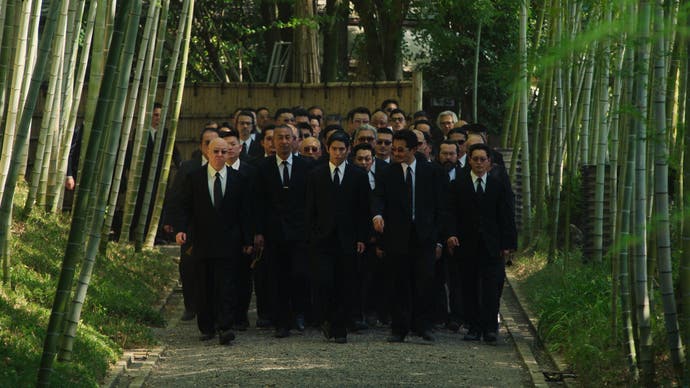 Like a Dragon: Yakuza TV series showing a group of gangsters in black suits amongst bamboo