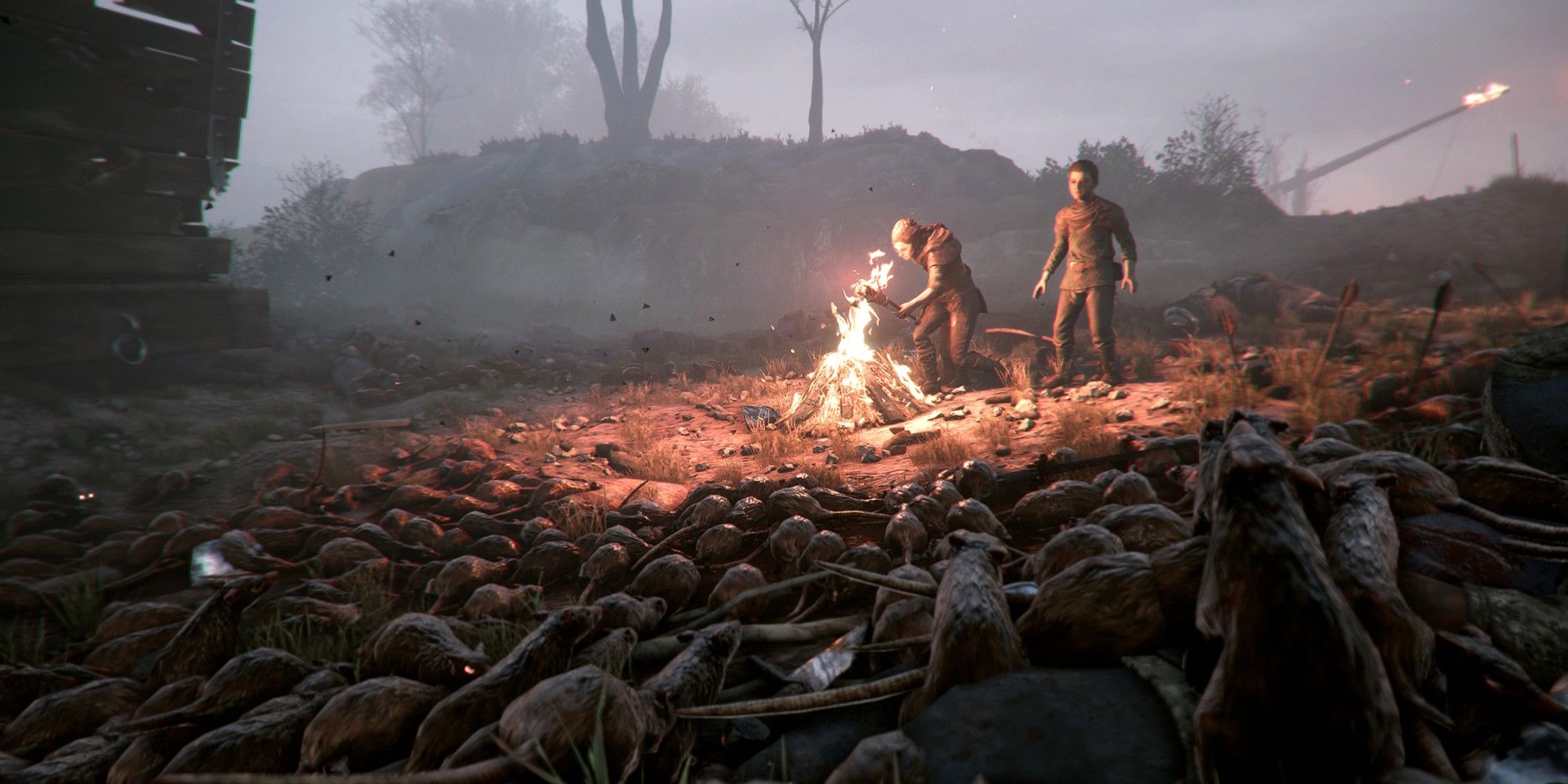 Image of rhe two protagonists fending off a rat horde in A Plague Tale.