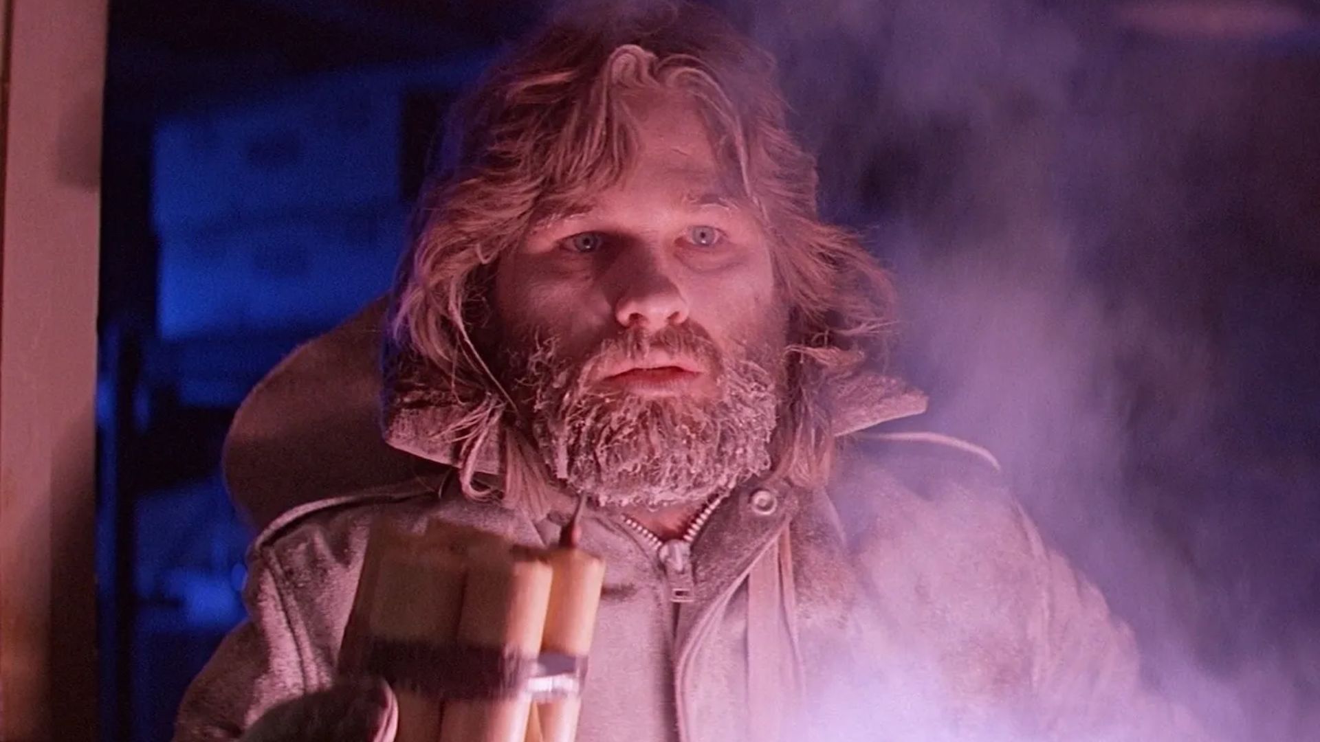 Kurt Russell in The Thing holding a stick of dynamite.