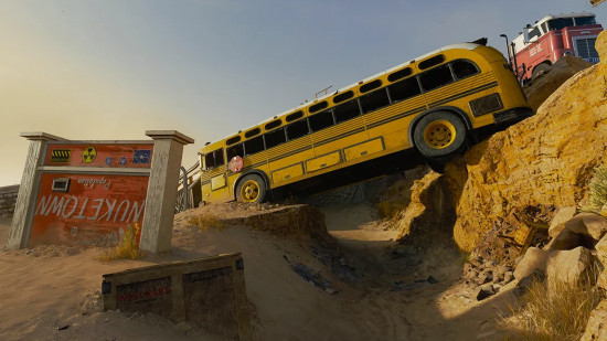 An old-school yellow bus rests over a ravine next to a red Nuketown sign in Warhead, one of the Black Ops 6 maps.