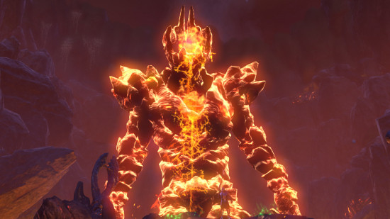 A giant fire character made of lava emerges from the gloom.