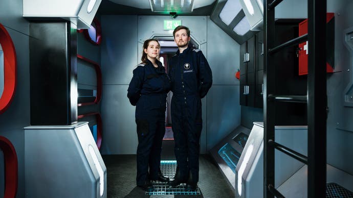 Bridge Command photo showing two crewmembers in a room with bunks and a ladder.