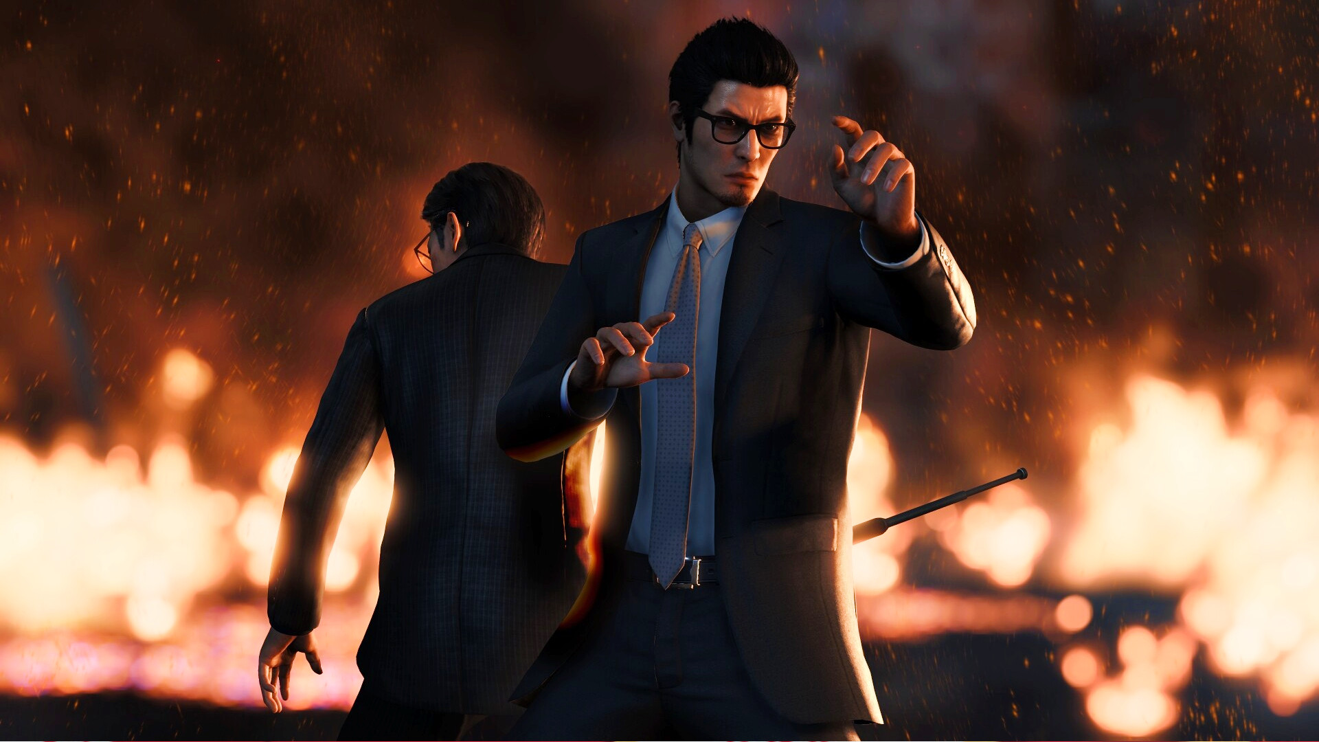 Like a Dragon Gaiden - Kiryu stands among burning flames.