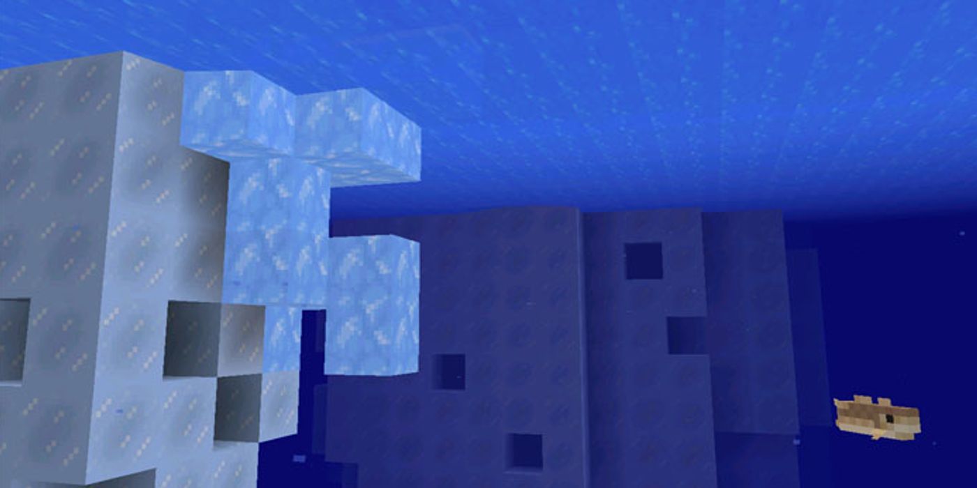 A player looking at blue ice attached to an iceberg underwater. 