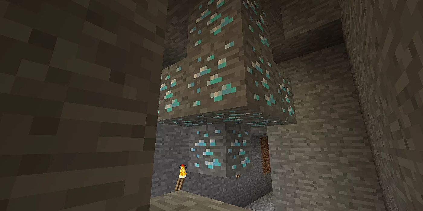 A player looking at diamond ore in a cave. 