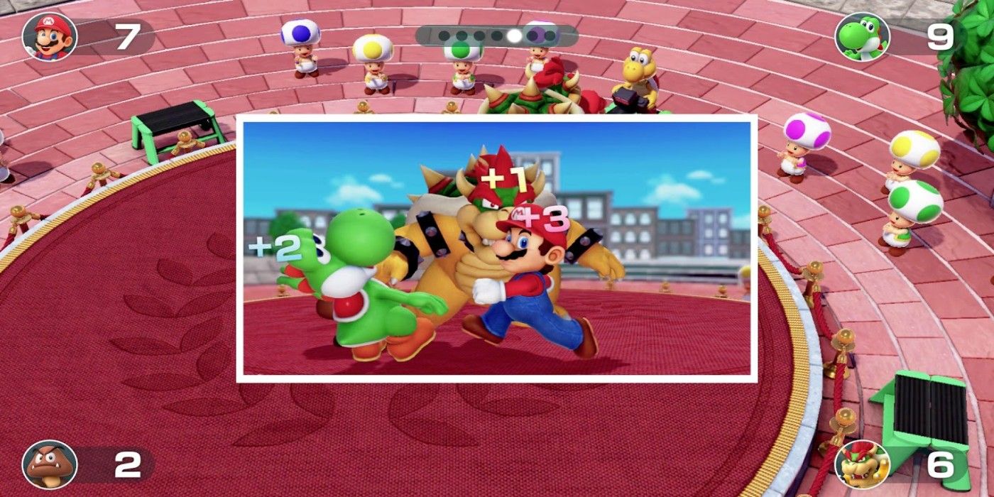 A photo of Mario, Yoshi, and Bowser slapping each other in the Slaparazzi minigame from Super Mario Party.