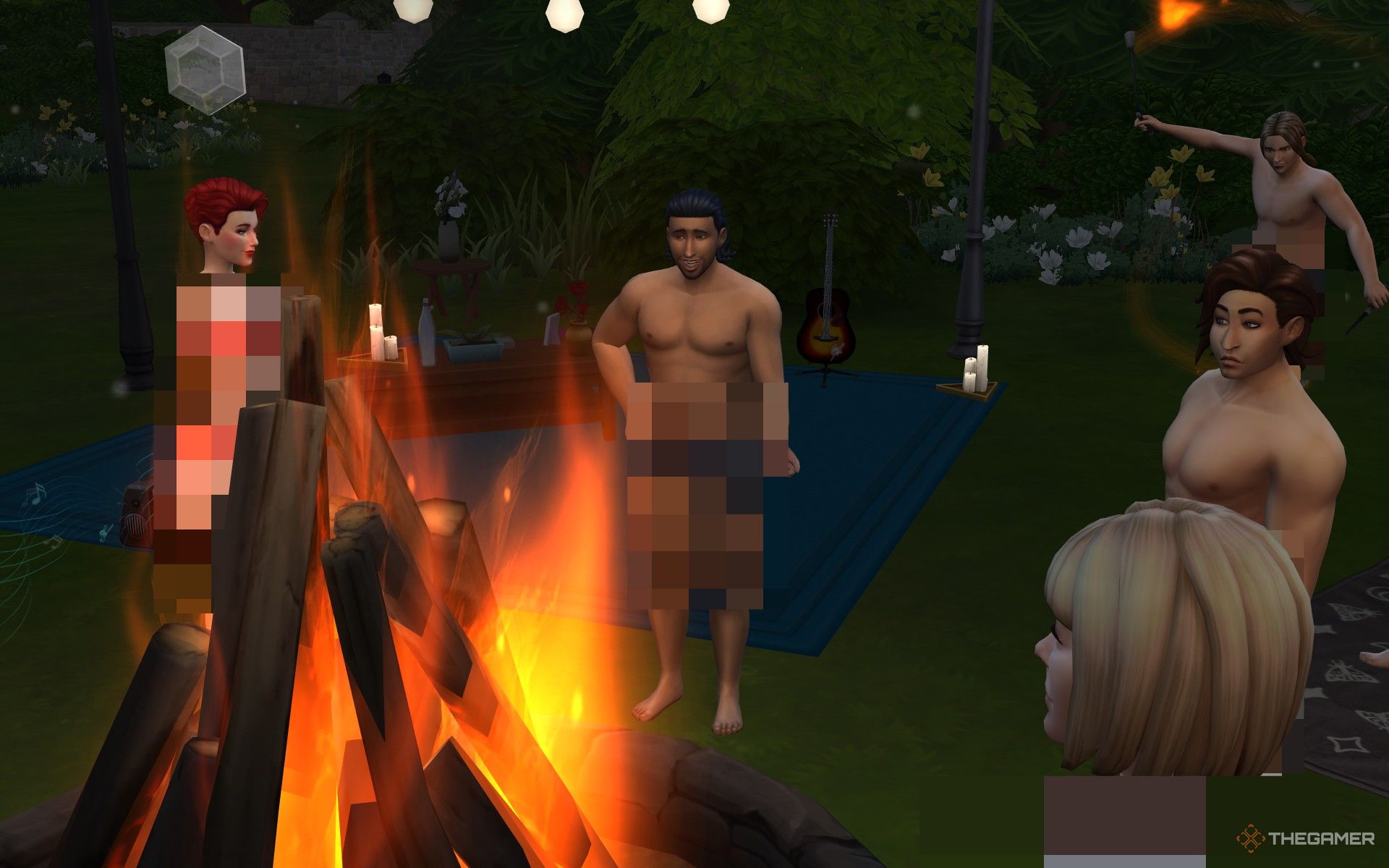 Sims dancing naked around a fire for the Moon Revelry in The Sims 4 Life and Death.