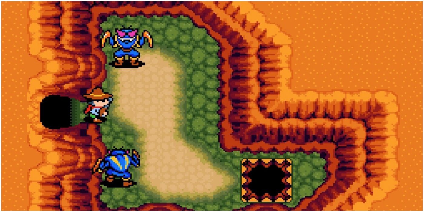 a character in a desert area surrounded by two blue enemies.