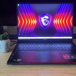 MSI Raider 18 HX gaming laptop open on a wooden gaming desk