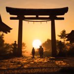 Naoe and Yasuke walk in the sunset in a screenshot from Assassin's Creed Shadows