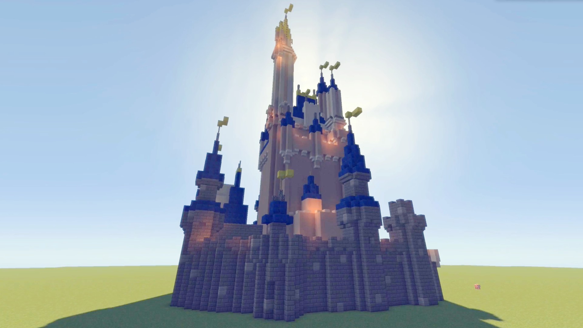 The sun shines behind a build of Cinderella's castle built in Minecraft.