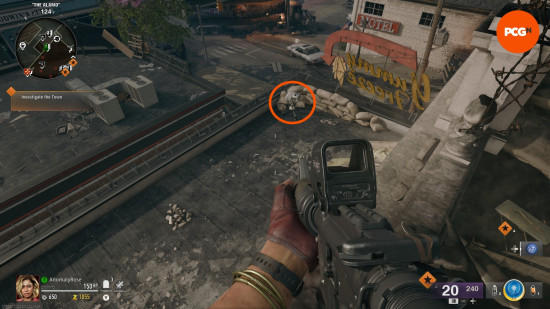 An orange circle highlights a white projector on the roof of Yummy Freeze in the Black Ops 6 Zombies Liberty Falls main quest.