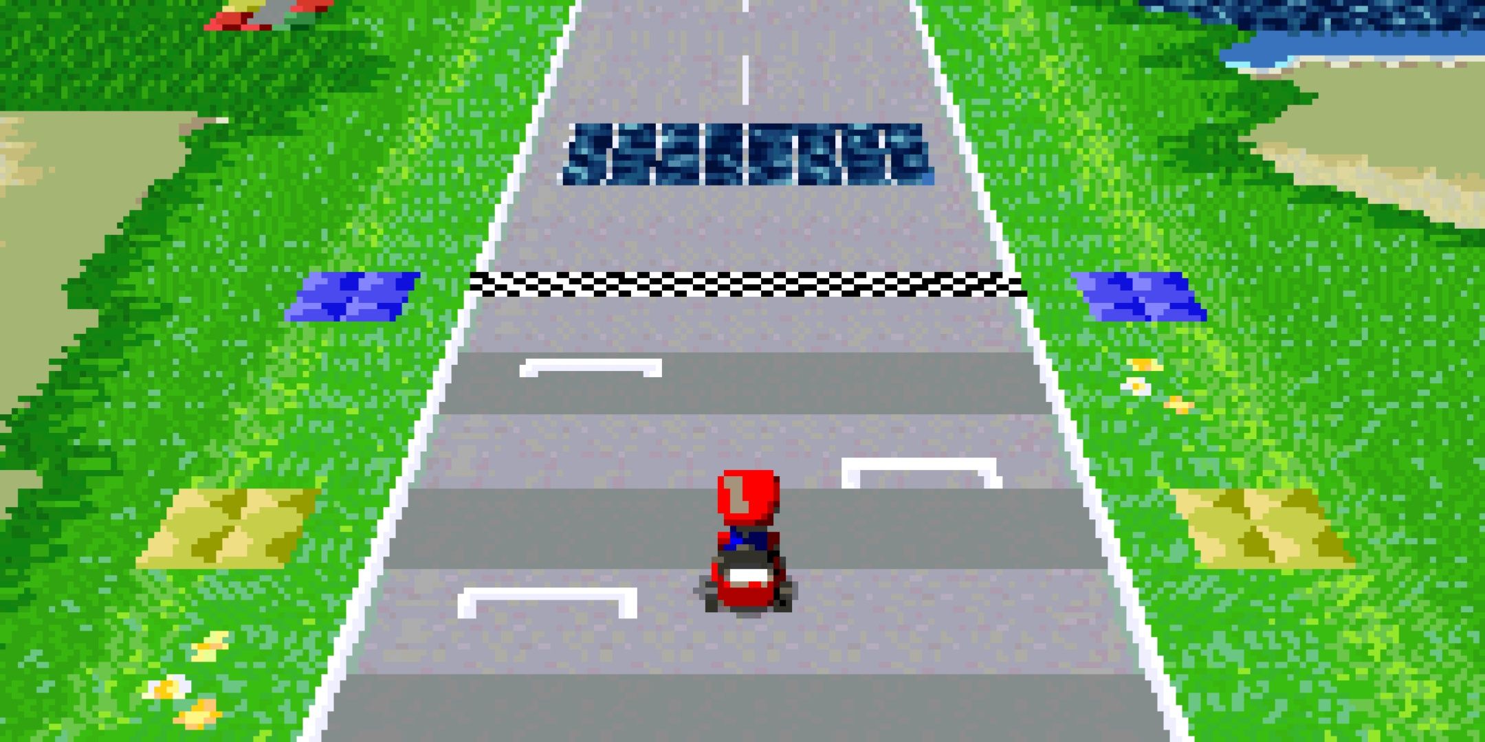 Mario in a race kart on a green track in mario kart xxl.