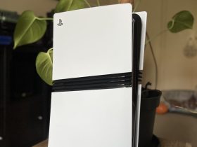 Top section of a PS5 Pro console in front of a houseplant