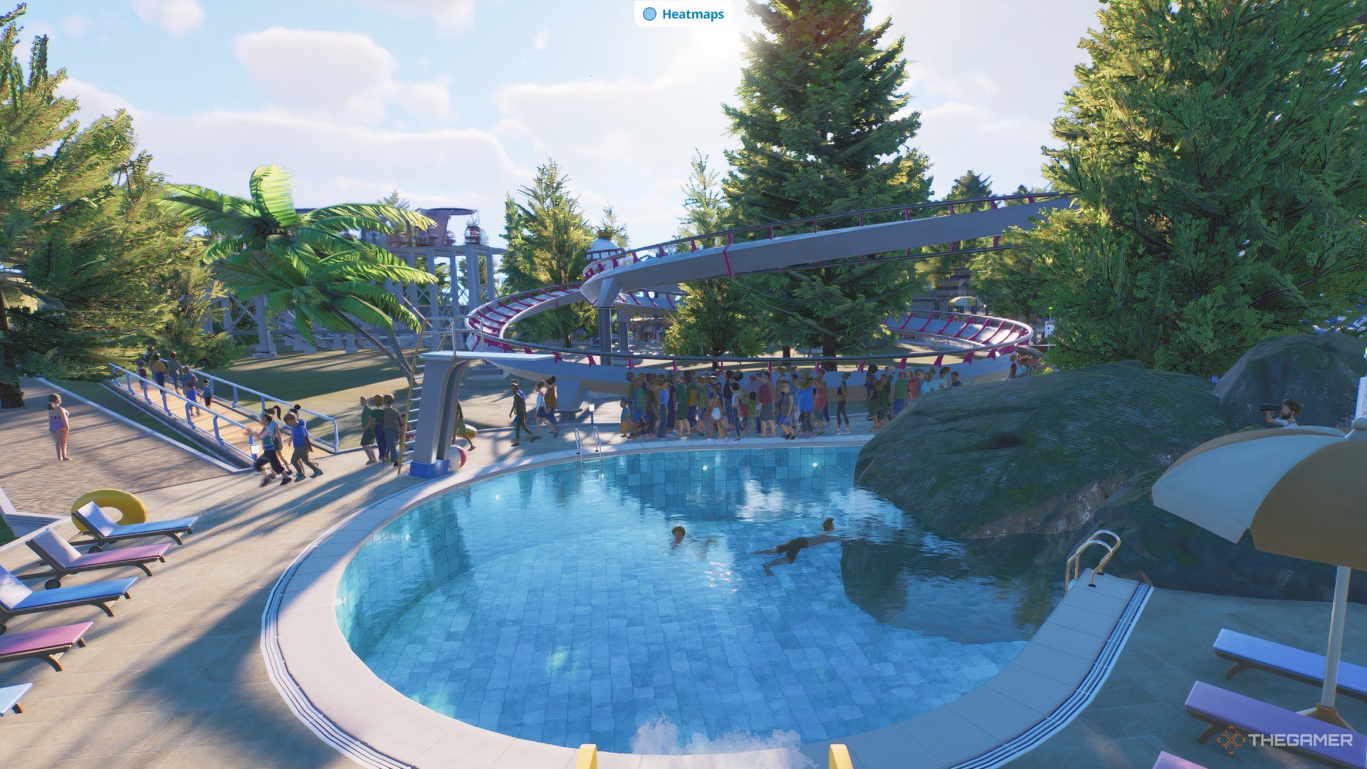 Guests swimming in a pool beneath a coaster.