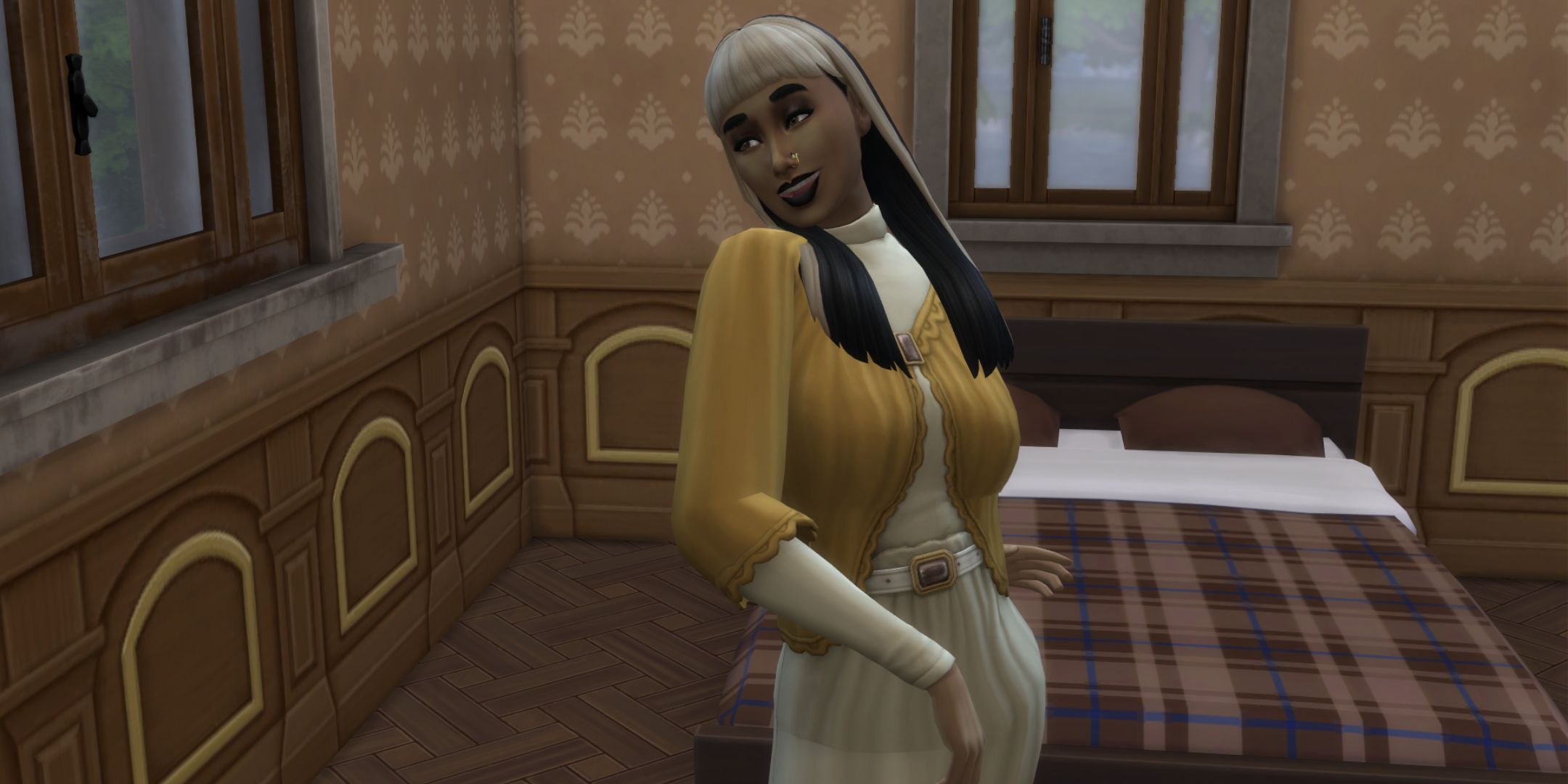 A sim changes her outfits in front of a bed. She is wearing a yellow sweater and cream skirt.