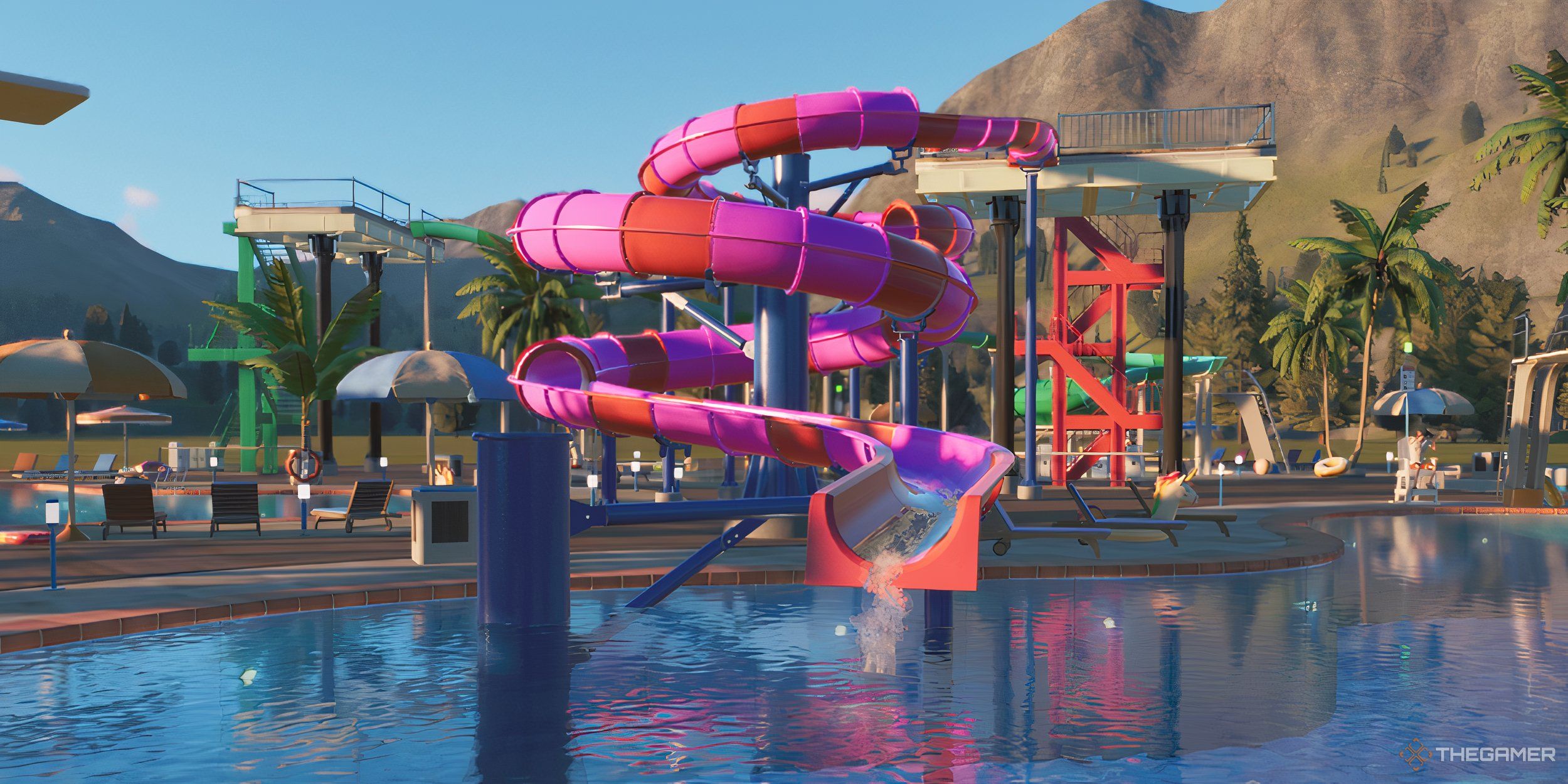 A large pink and red flume ride dropping into a pool in the mountains.