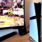 PS5 Pro next to monitor with Ratchet and Clank: Rift Apart gameplay on screen