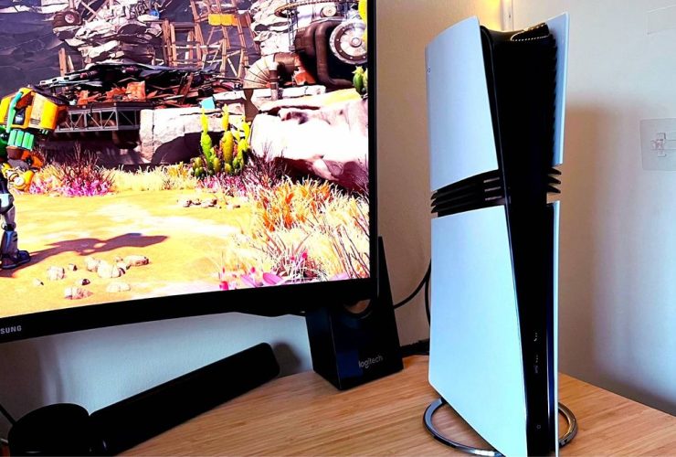 PS5 Pro next to monitor with Ratchet and Clank: Rift Apart gameplay on screen