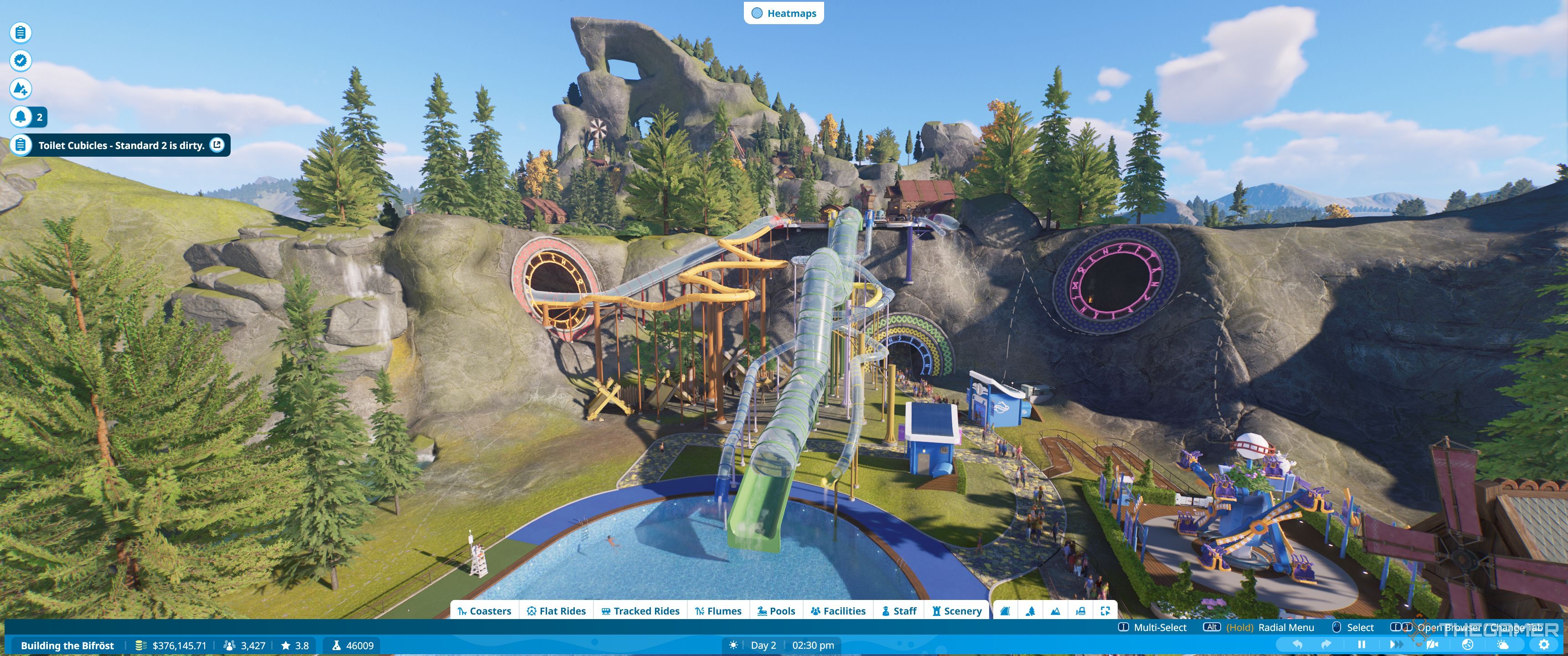 Planet Coaster 2 flumes coming down into a pool and into a hole in a cliff.