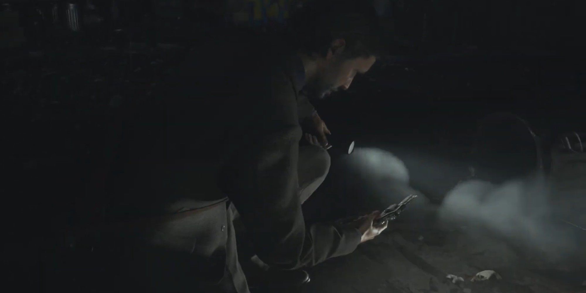 Alan Wake 2 image showing Alan finding the Revolver on the ground in the alley.