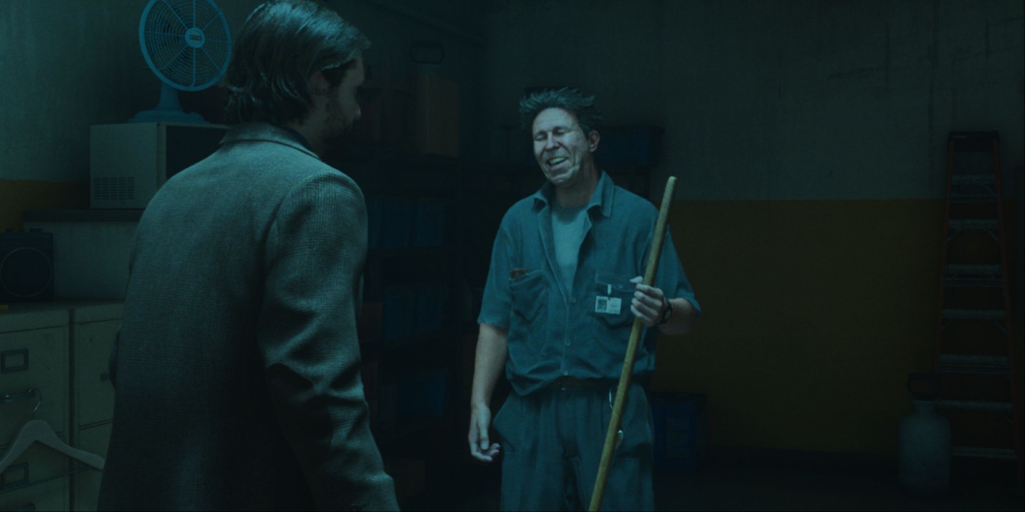 Alan speaking with Ahti from Control in his janitor's room, Ahti's expression is smiling with laughter.