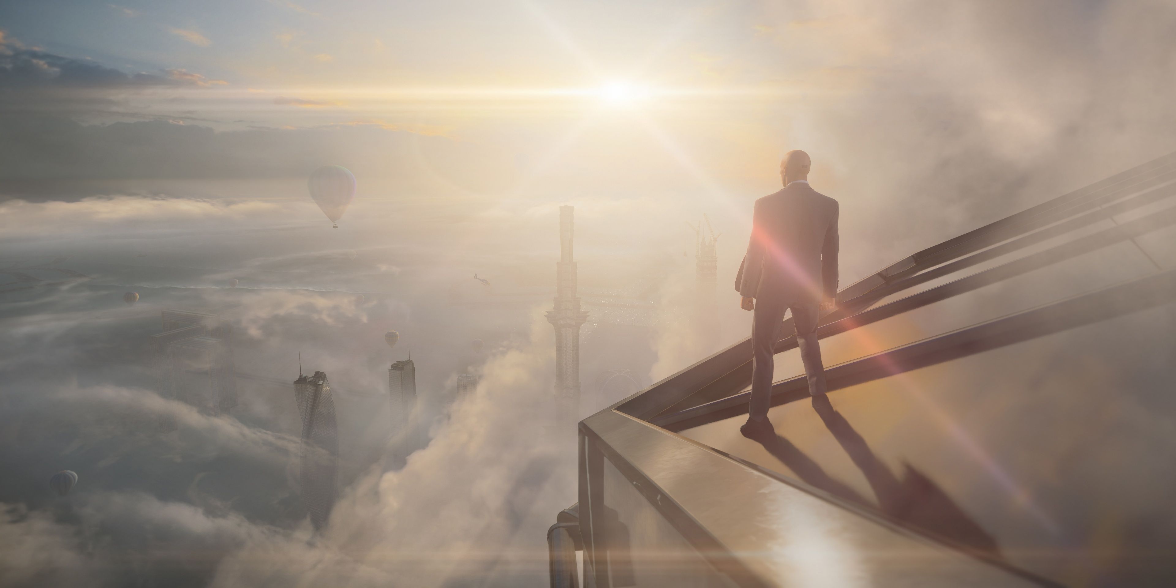 A screenshot showing Agent 47 standing on the edge of a rooftop in Hitman 3.