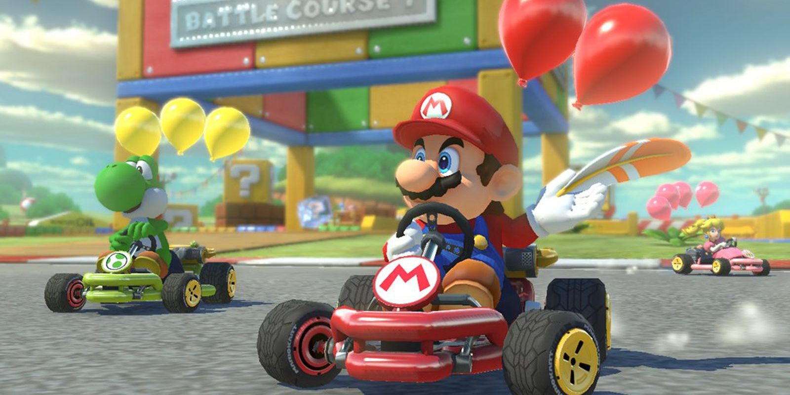 Mario Kart 8 Deluxe screenshot of Mario and Yoshi racing with balloons on their karts.