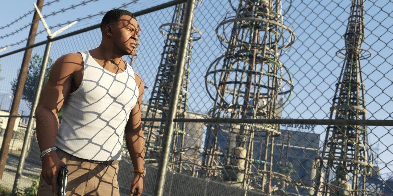 Franklin walking along a fenced off power plant in GTA 5.