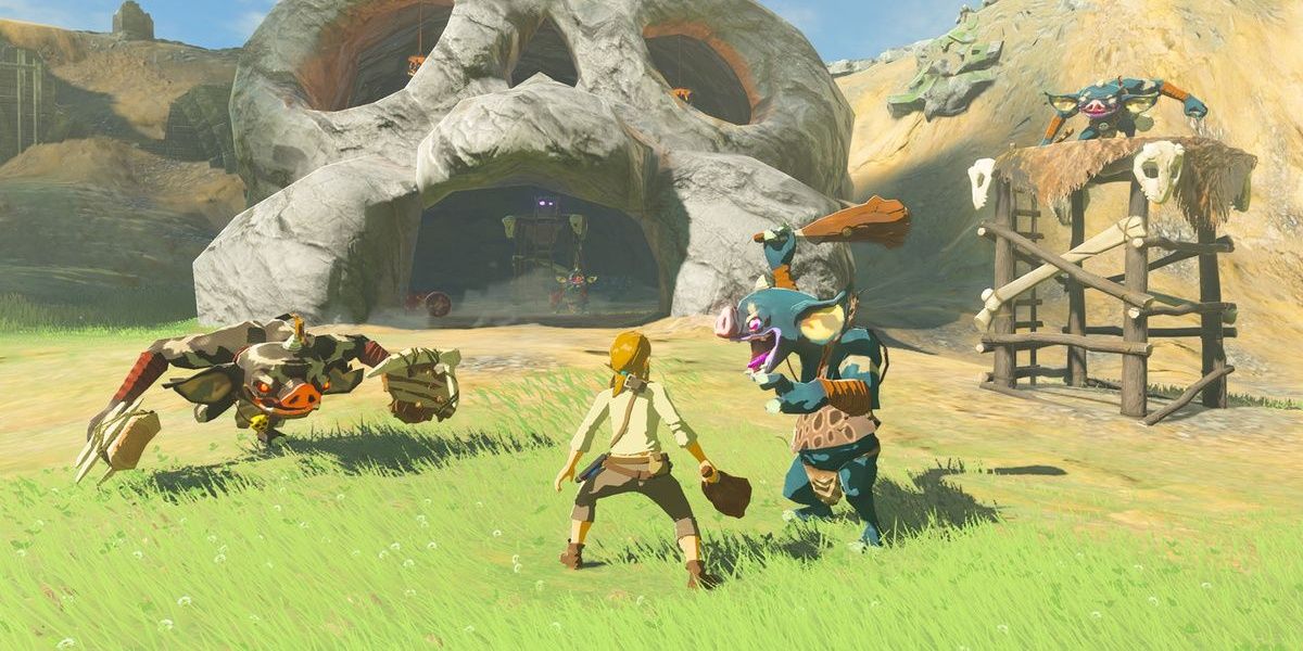 Link getting attacked by Bokoblins by a skull hideout in Breath of the Wild.