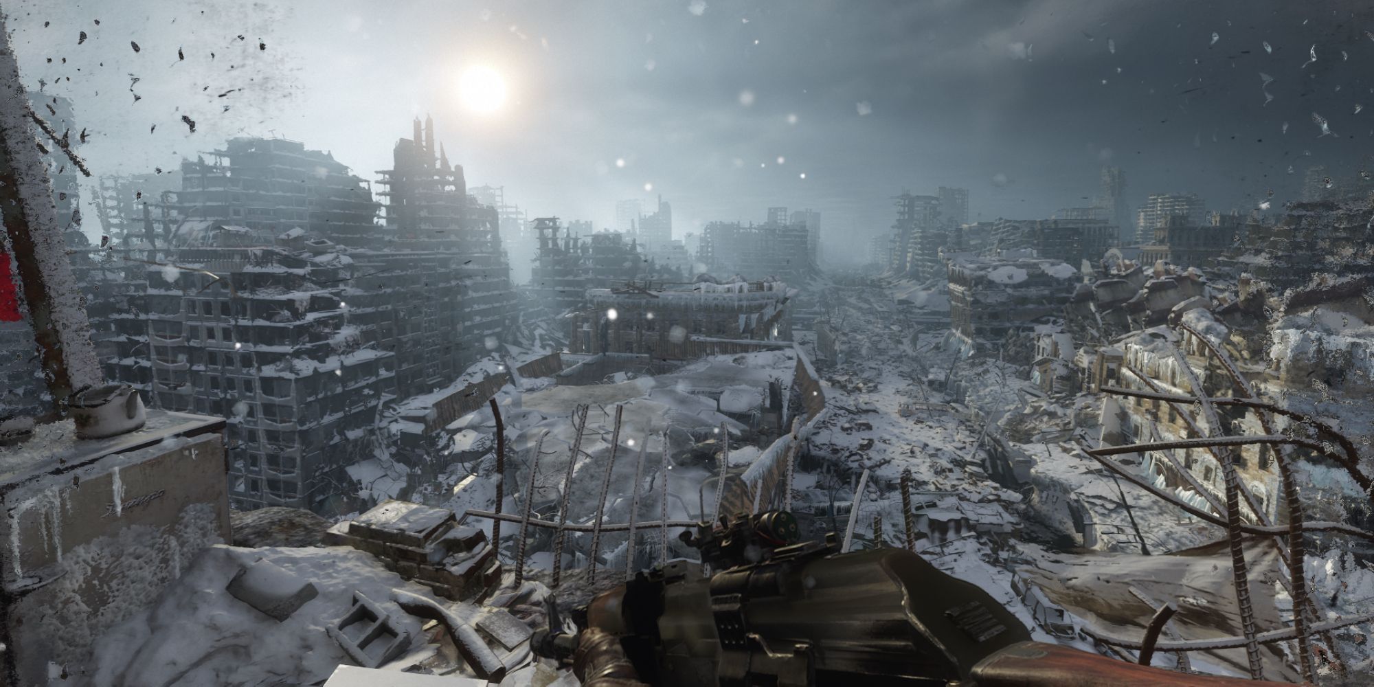 A screenshot from Metro: Exodus Enhanced Edition (2020) wherein the player is perched atop a high building, looking at a panoramic view of a destroyed city, covered in snow in a post-apocalyptic setting.