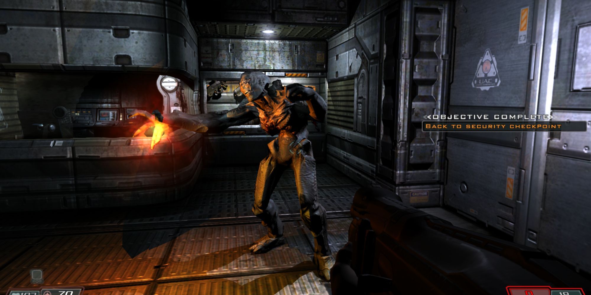 A screenshot from Doom 3: BFG Edition where the player is fighting a demon classified as an "Imp" in a facility on Mars.