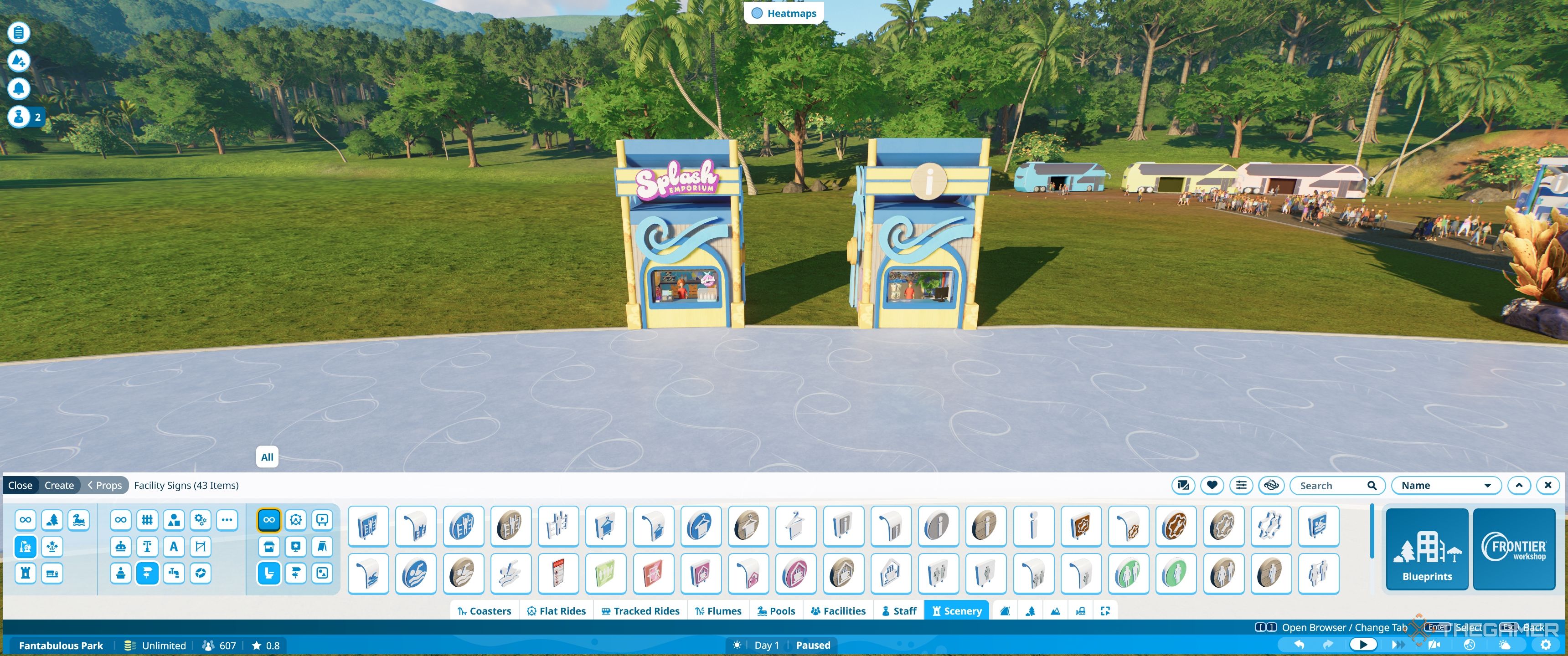 Planet Coaster 2 Custom yellow and blue shop shell with splash emporium and info desk.